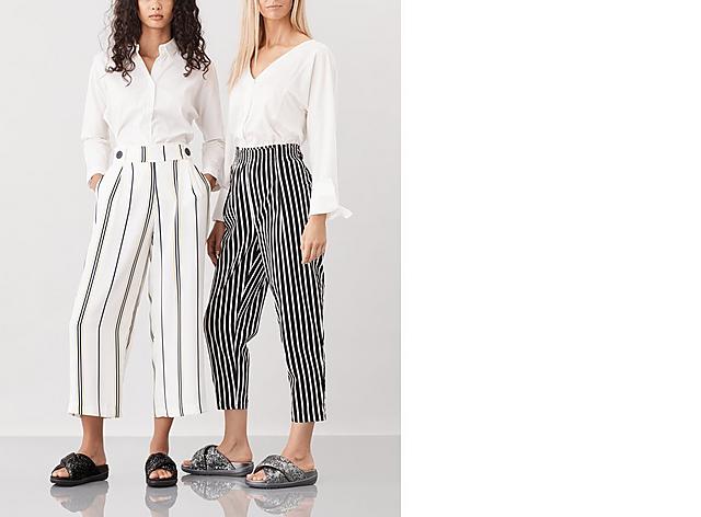 Two models wearing Loosh Luxe sequin Cross slide Sandals, shown in colours Silver and Black.