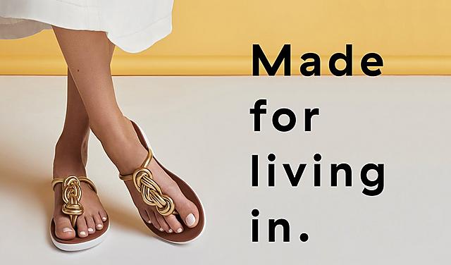 Women wearing Twiss Gold Leather Toe-post sandals.  featuring two large twisted braid.