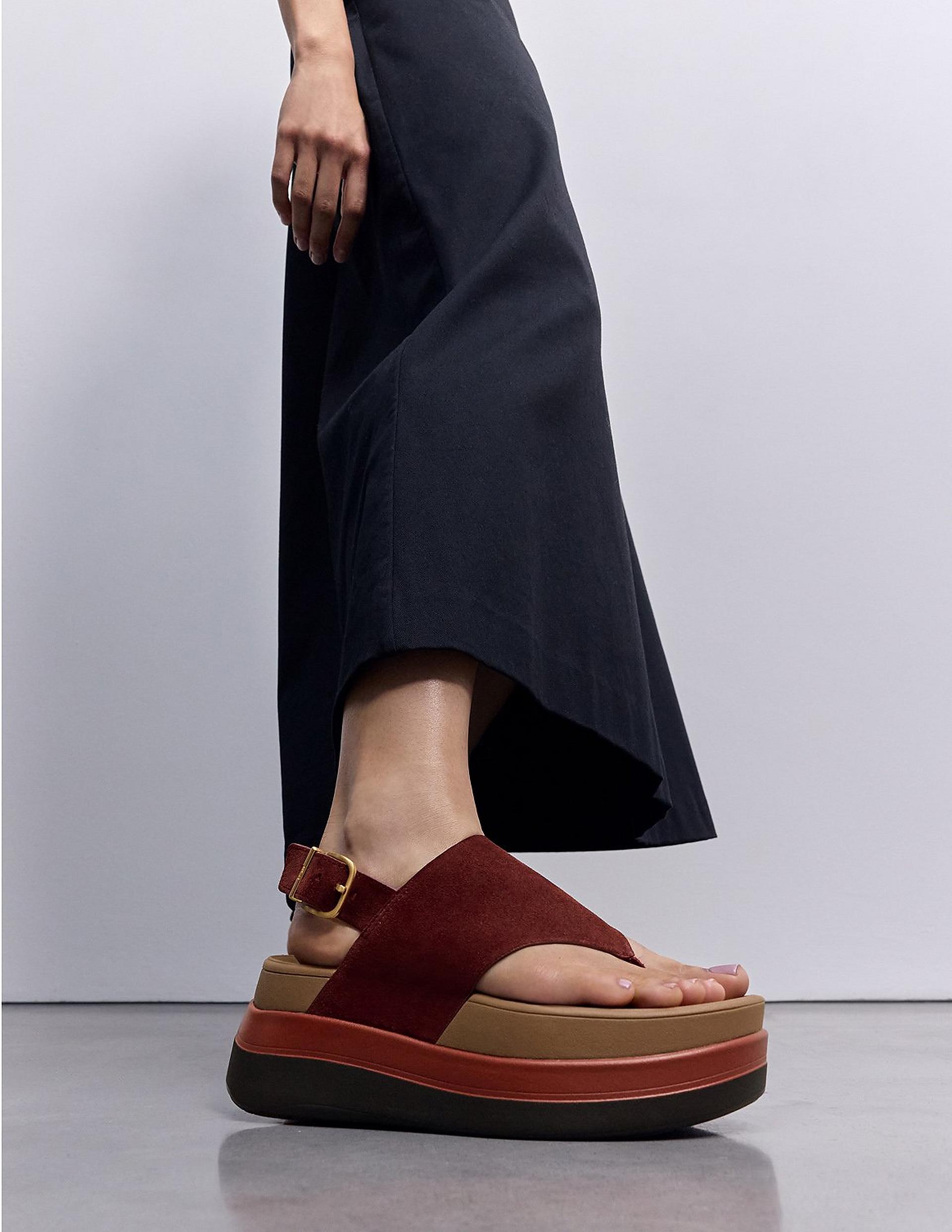 woman wearing black plafform stack sandals