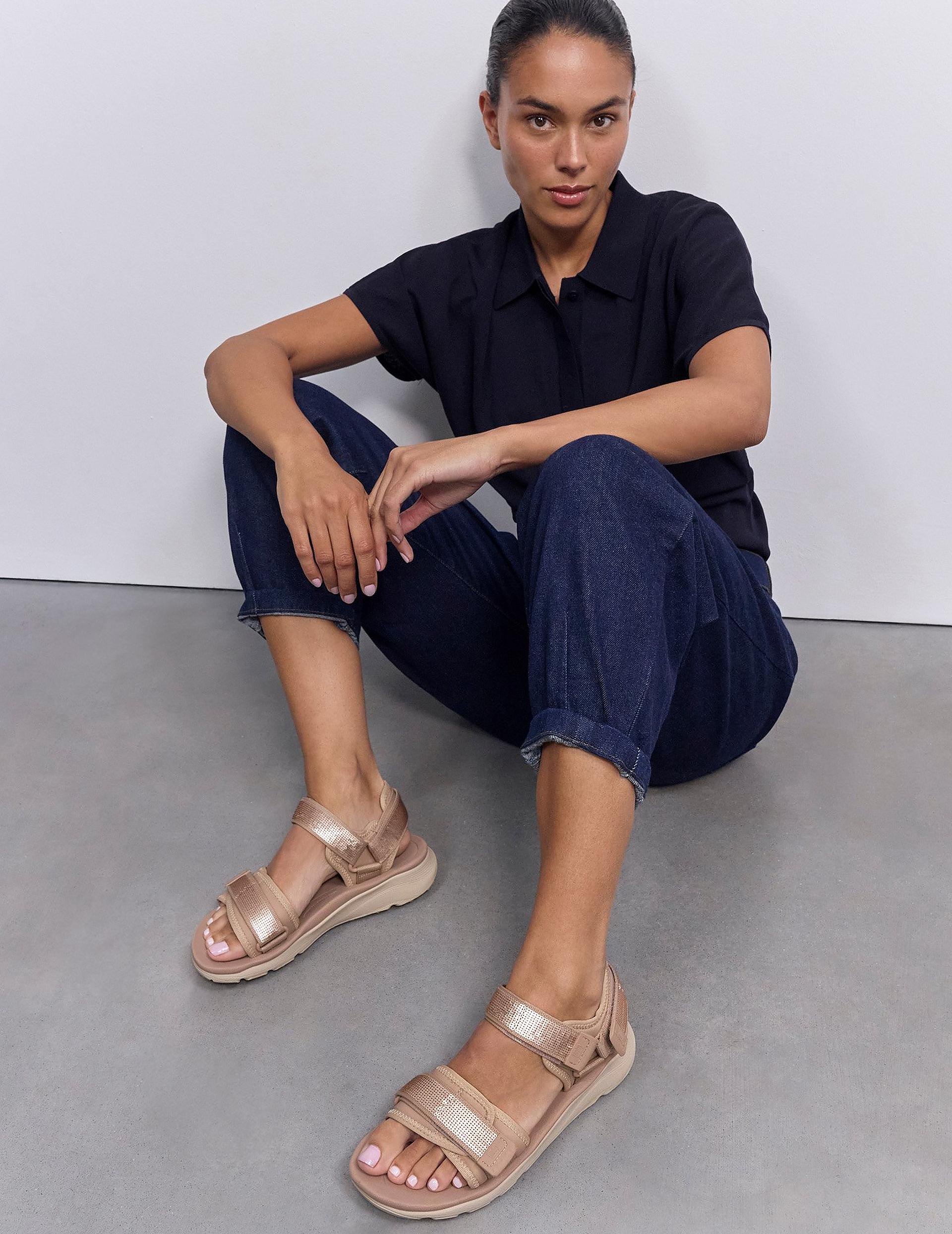 woman sitting down wearing neo d hyker sandals 
