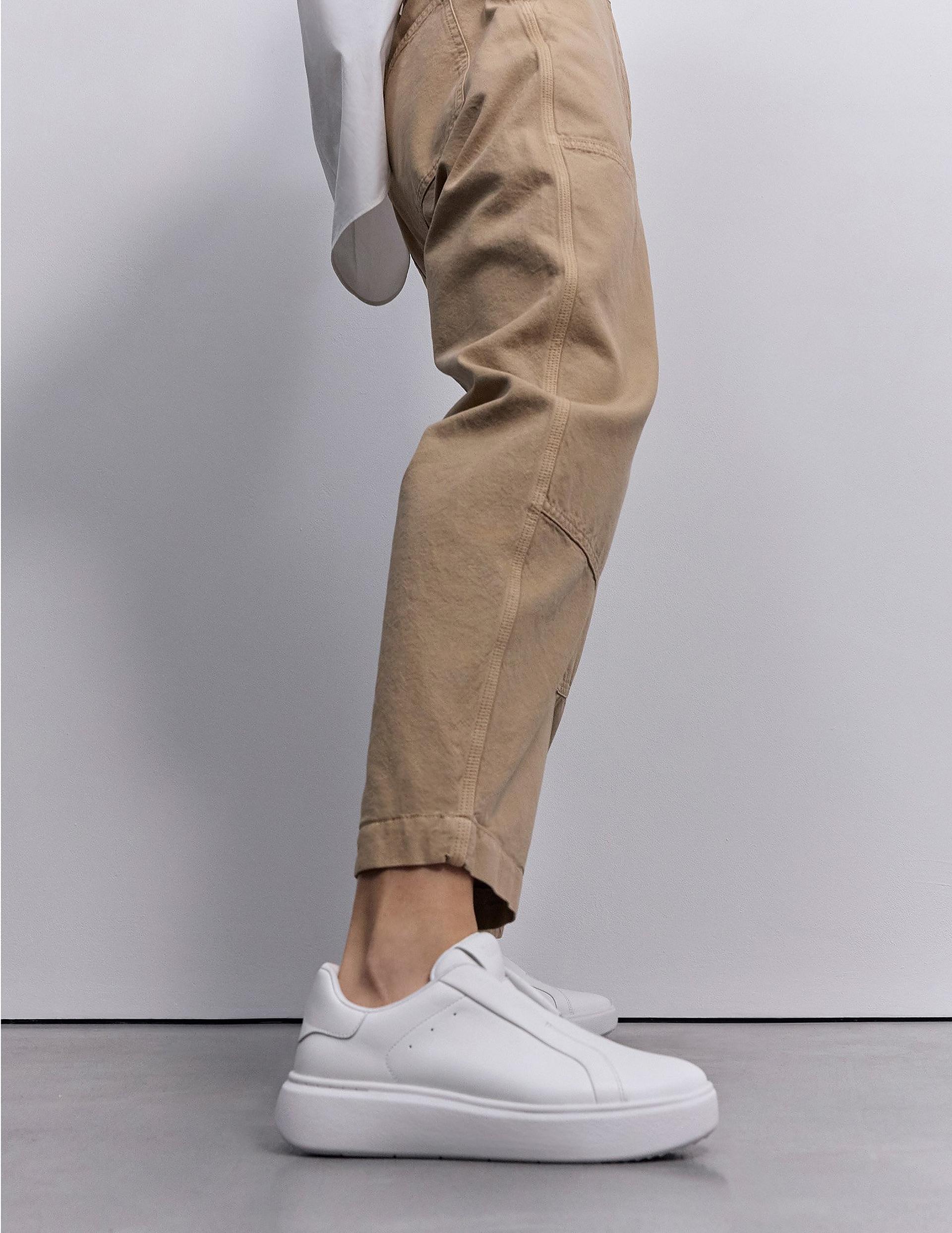 Woman wearing RTG White Sneakers
