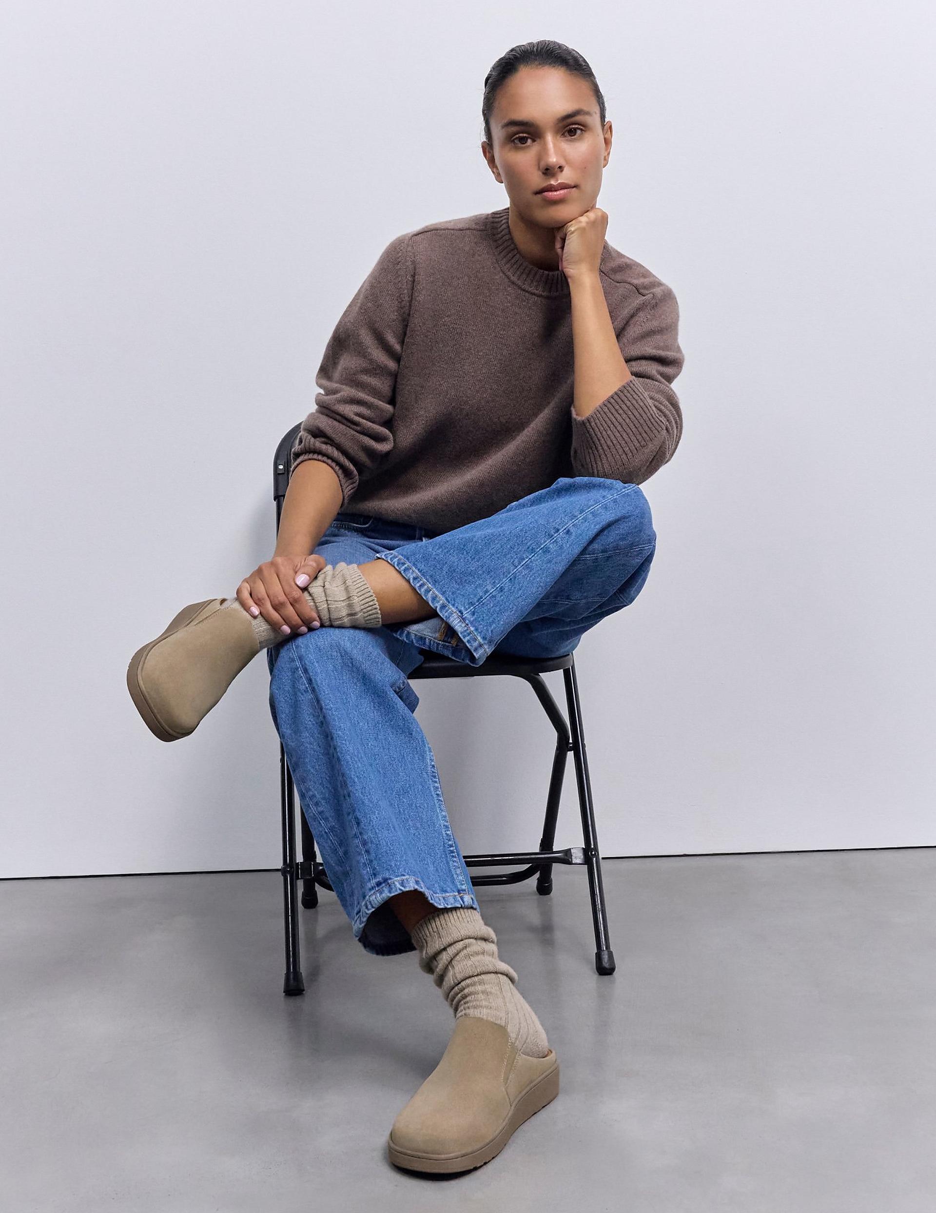 woman wearing mules in beige suede