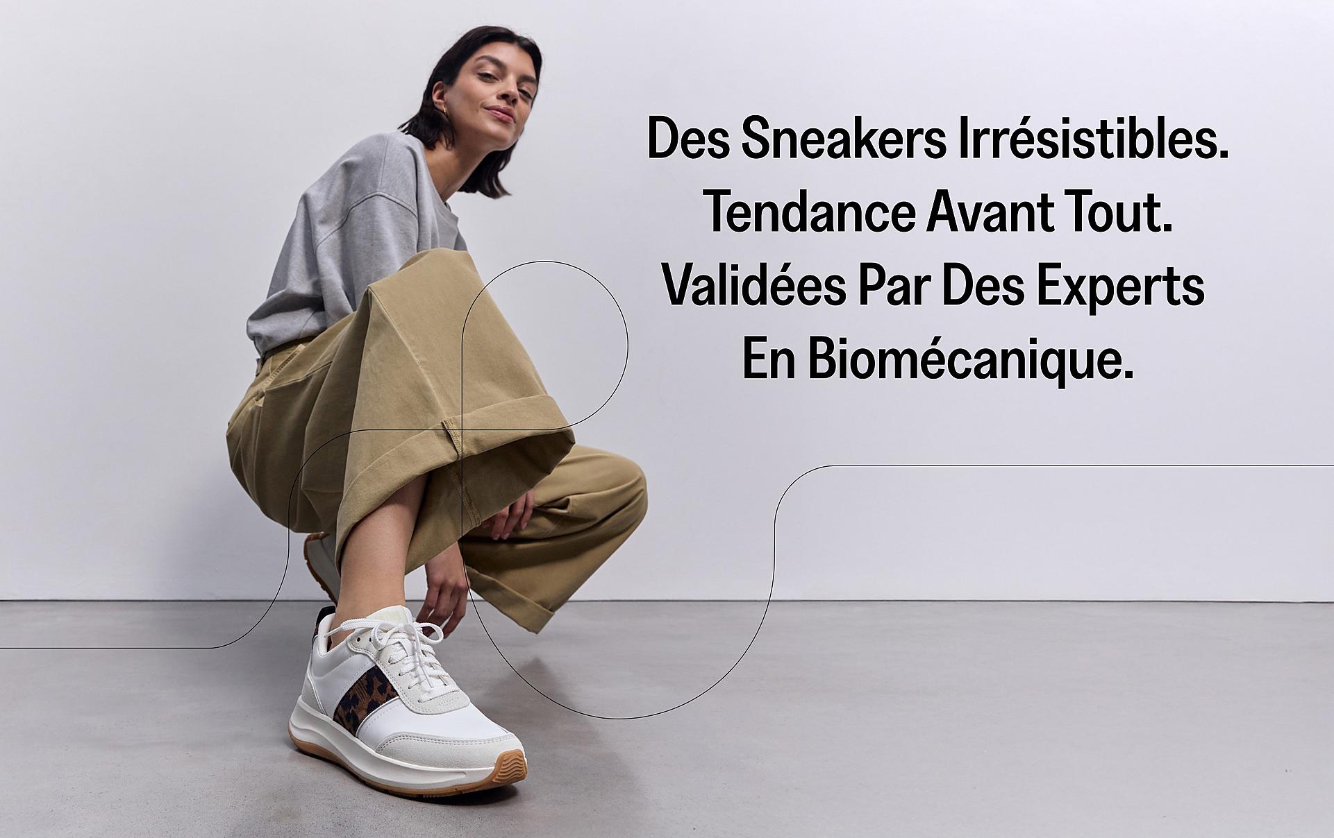 model squatting down wearing fmode leopard print sneakers from fitflop