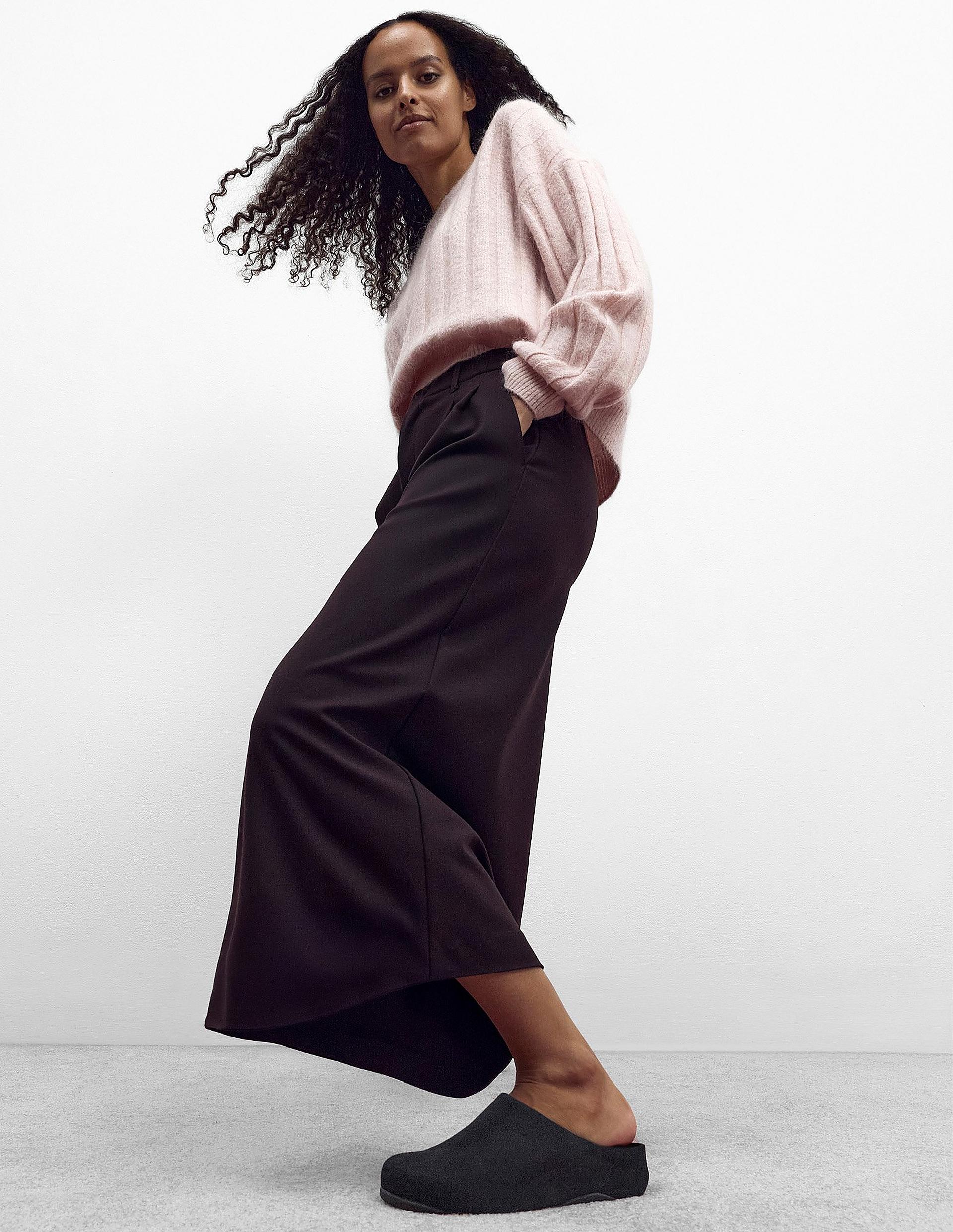 Model standing up wearing leather shuv clog