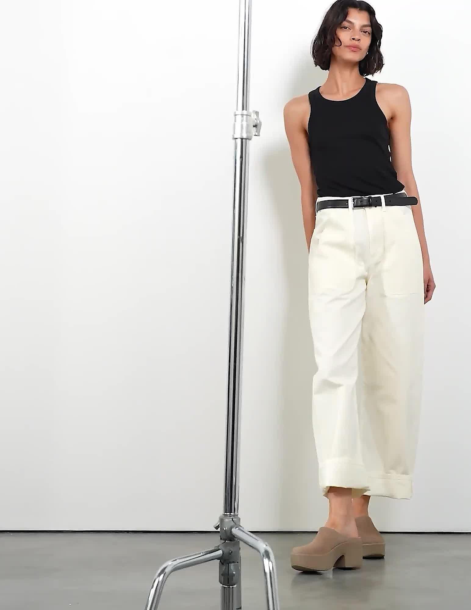 Woman wearing jeans, a top and platform mules