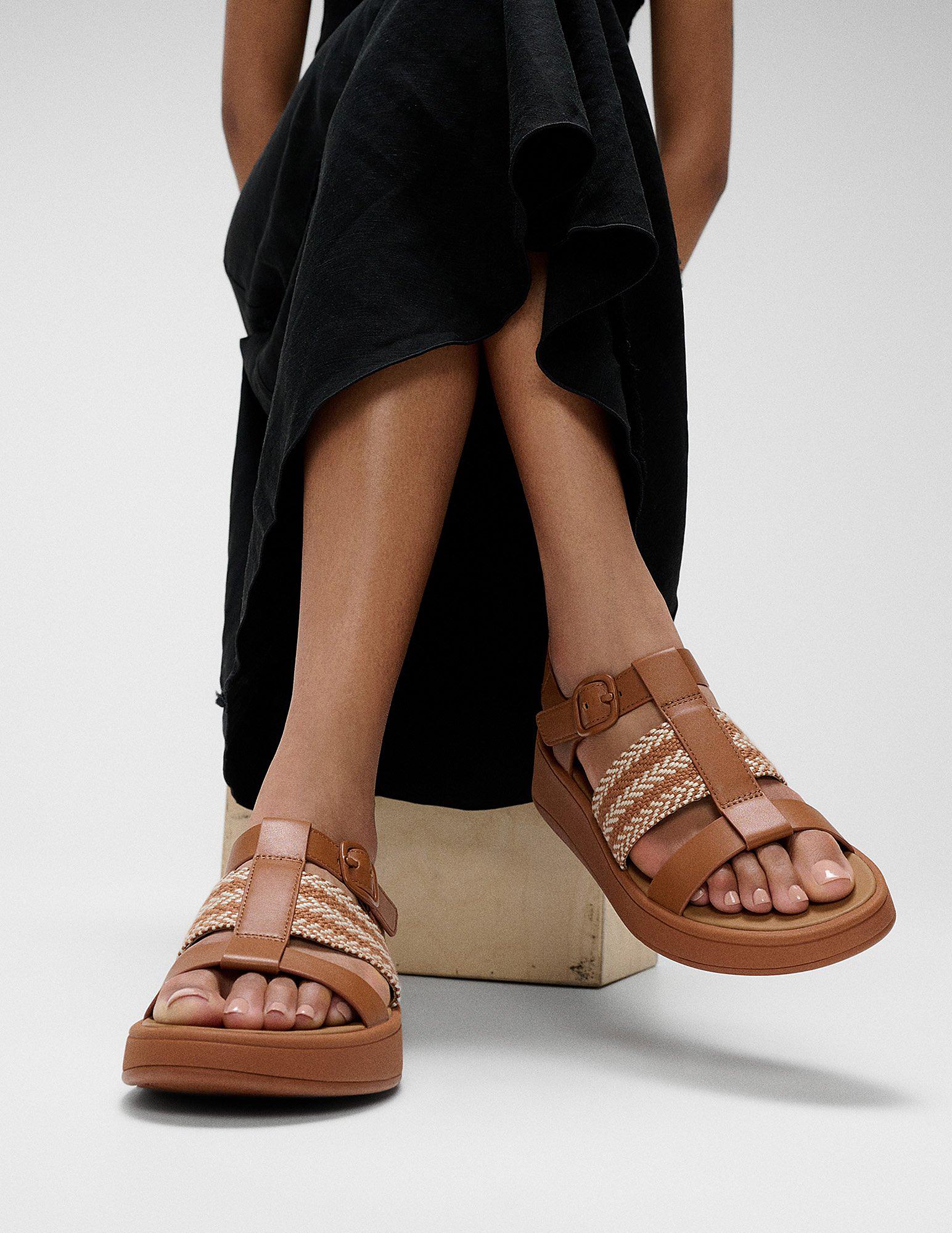 Woman wearing black skirt and F MODE fisherman sandals - From FitFlop UK