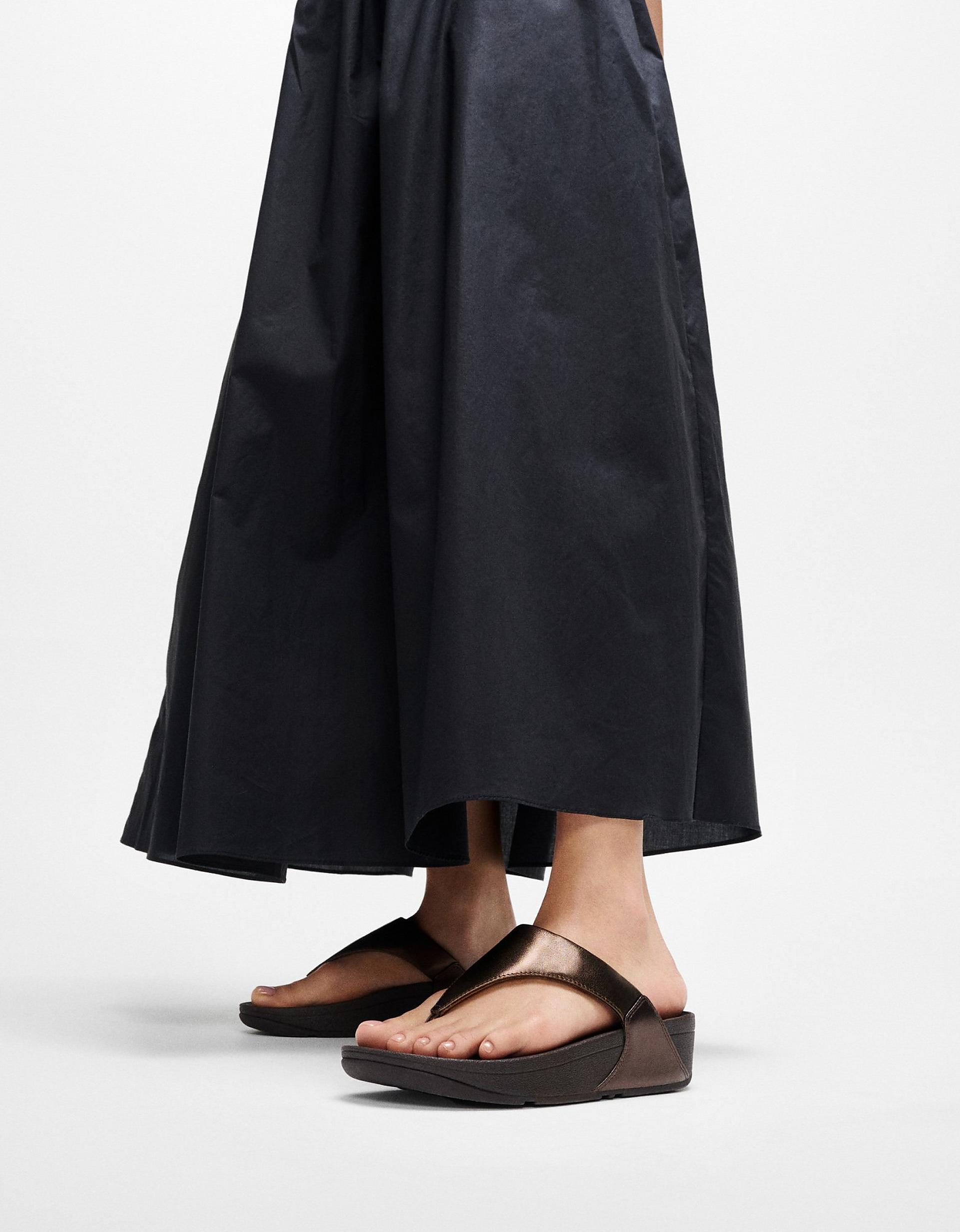 Woman wearing black skirt and F MODE fisherman sandals - From FitFlop US