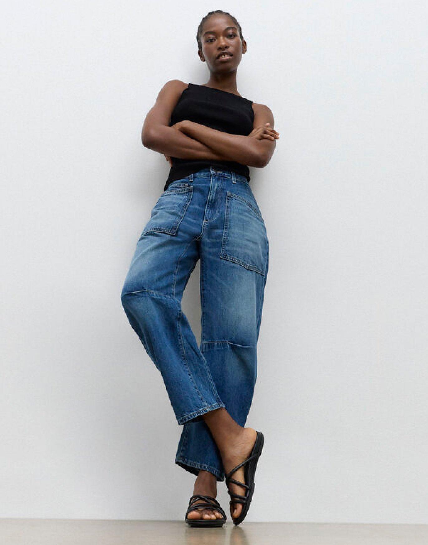 Model Wearing Strapy Staps Gracie Sandals In Black Standing Up