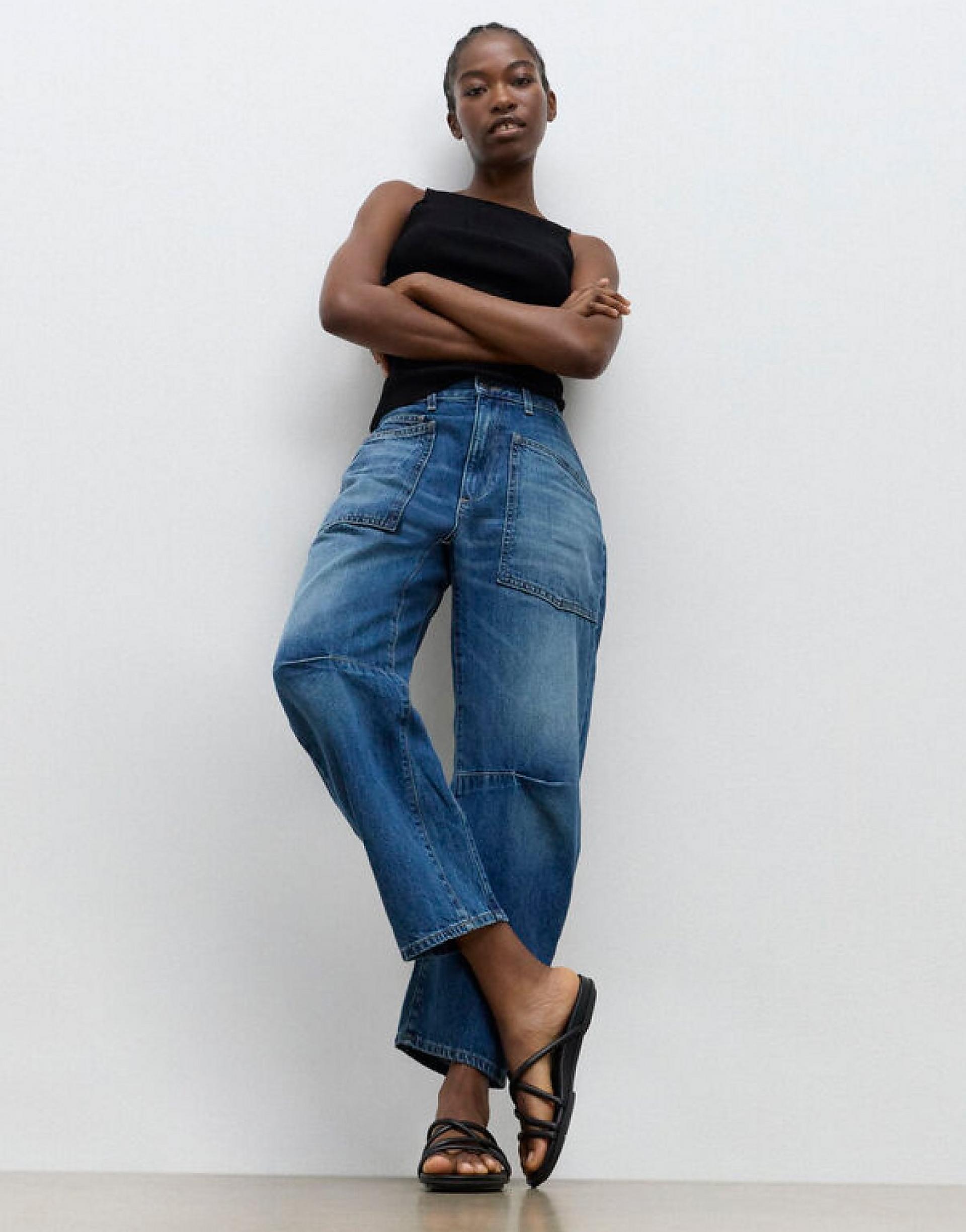 Model Wearing Strapy Staps Gracie Sandals In Black Standing Up