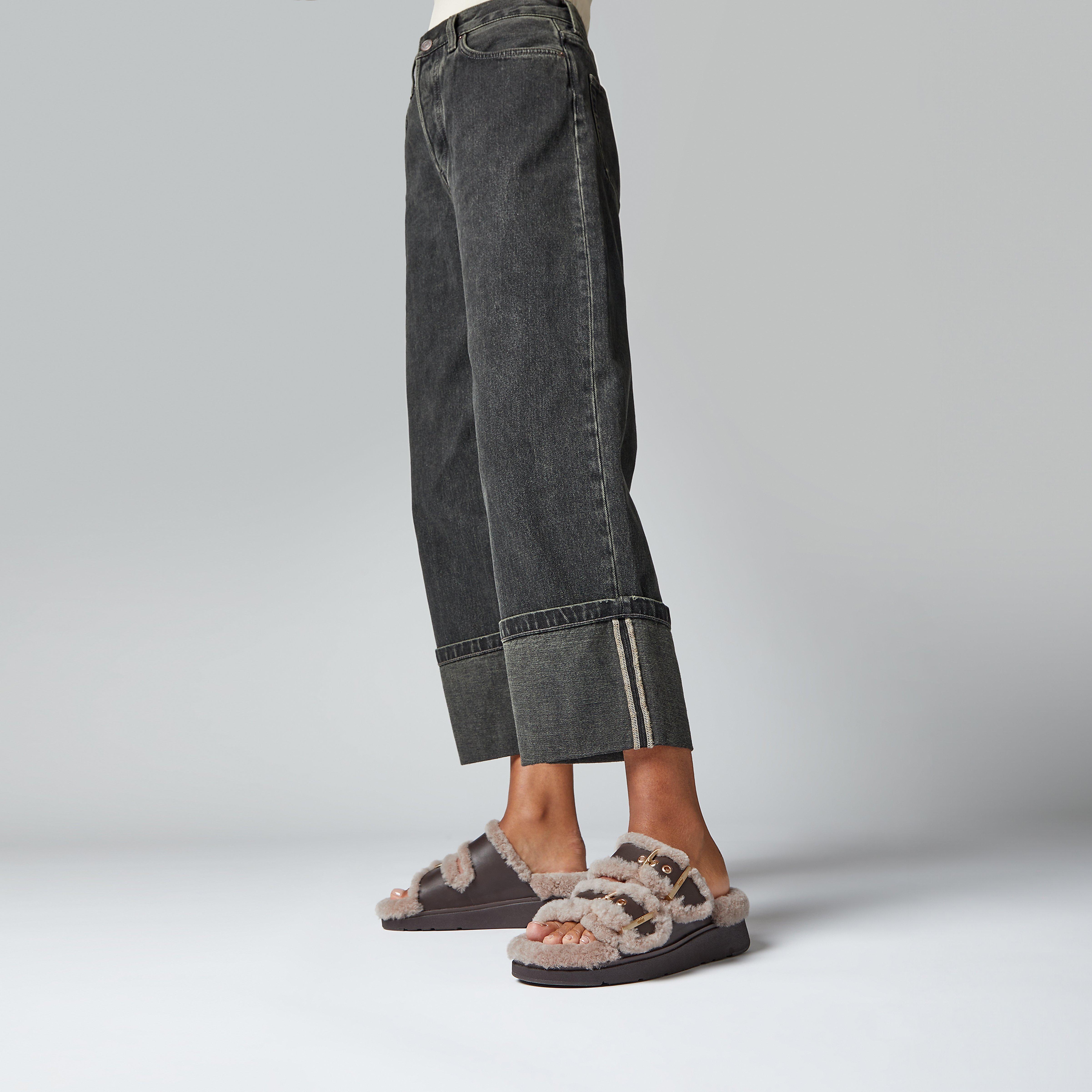 GEN-FF Shearling Two-Bar Slides in the colour Brown Mix. Styled by a model wearing black jeans.