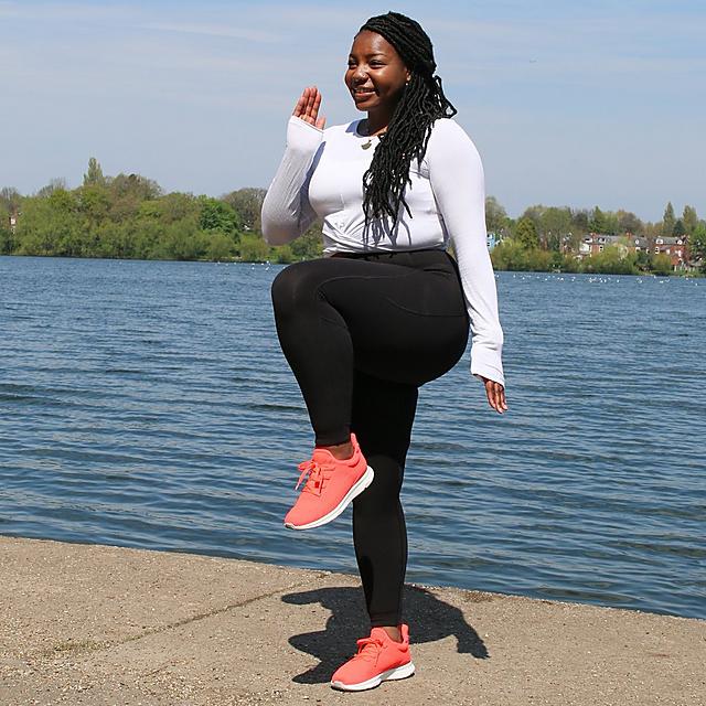 Woman wearing VITAMIN FFX trainers showing energy boosting exercise.