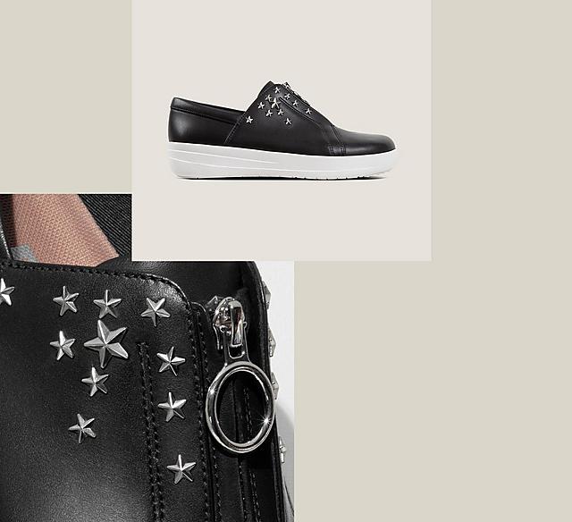 Black leather sneakers with silver star studs on the side and zip opening.