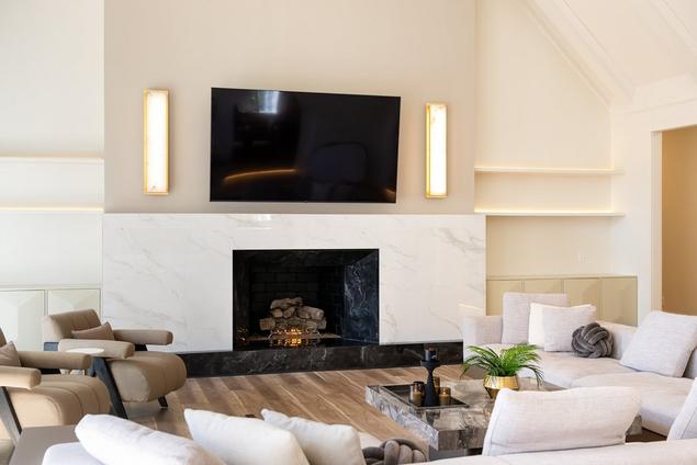 Fireplace with Andover White Porcelain Tile surround and Onyx Noir Porcelain Tile hearth.