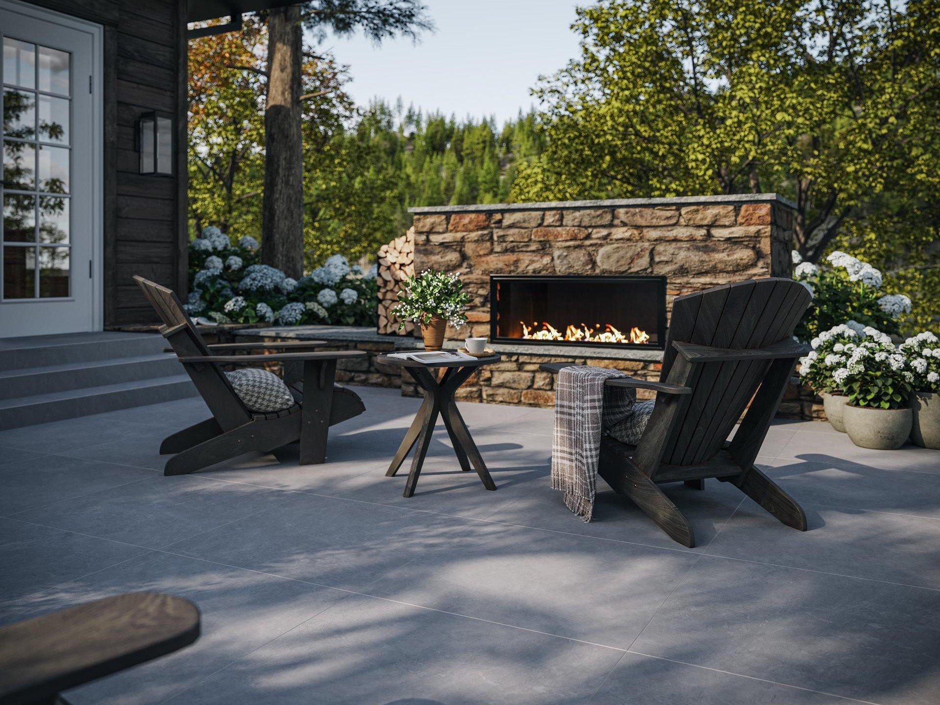 Cozy outdoor patio with a rustic stone fireplace.