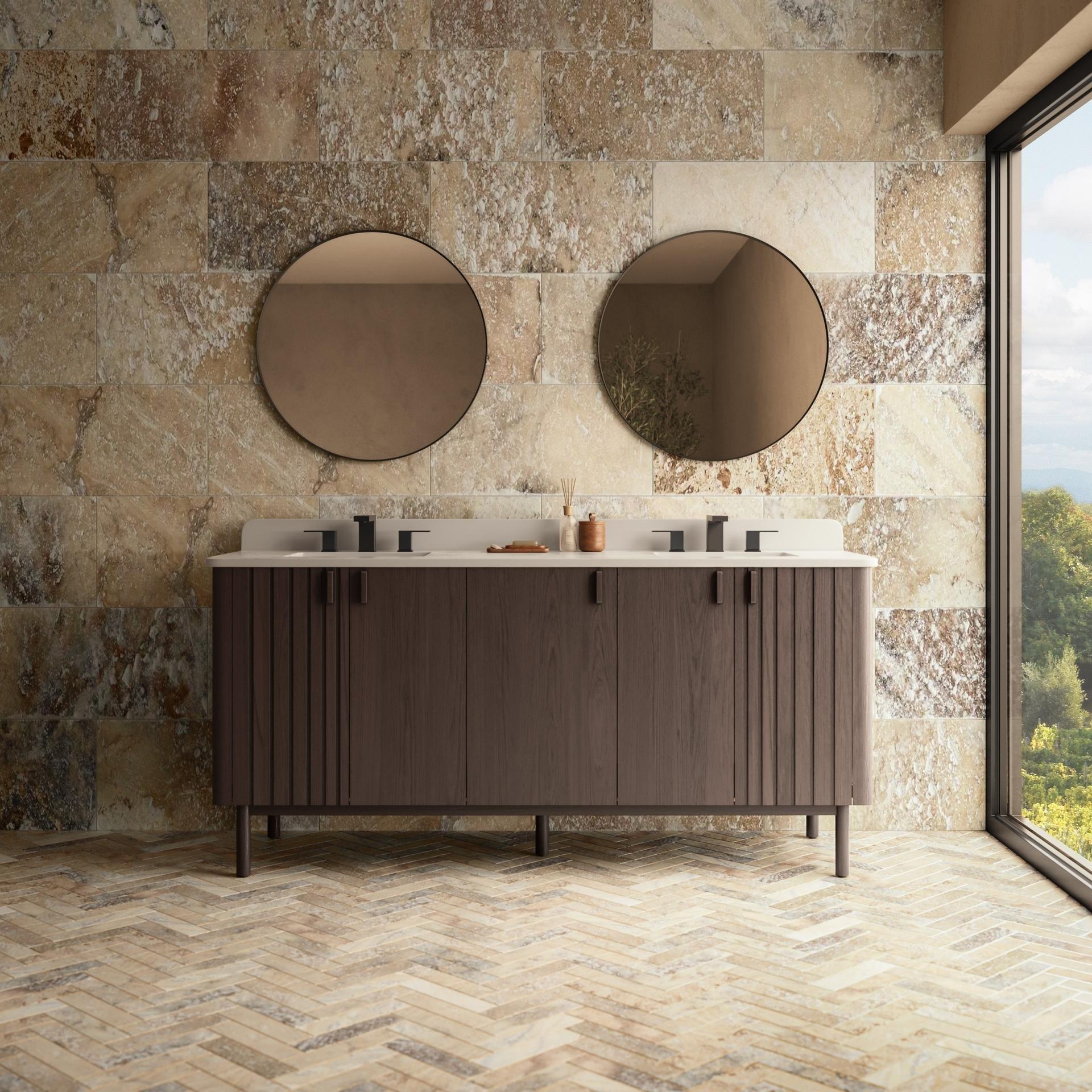 Bathroom with travertine walls and herringbone pattern floors.