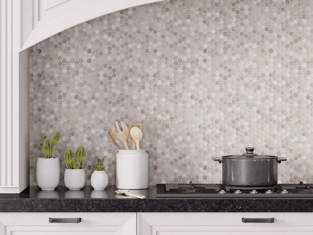 Kitchen backsplash with white, gray, and beige penny tile. 