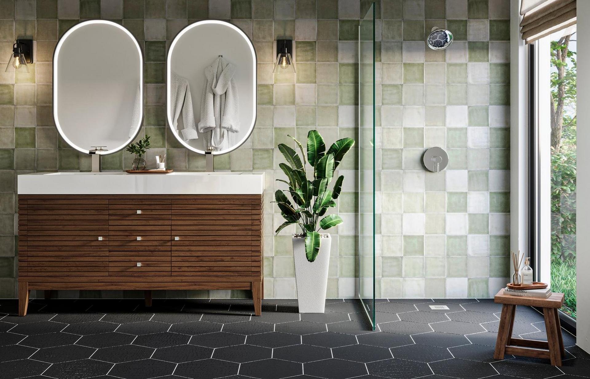 Bathroom with green wall tile, black floor tile, and marble top wood vanity