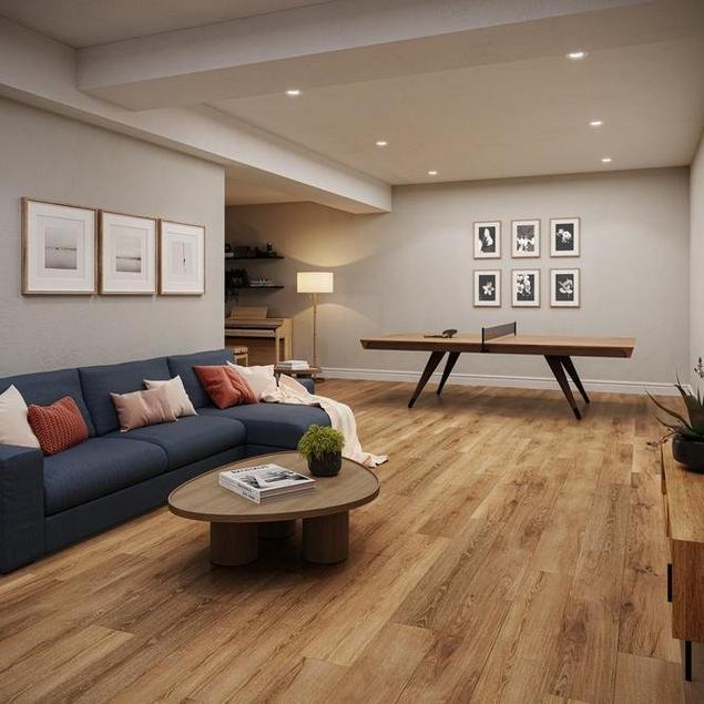 Light gray basement with medium brown performance floors, blue fabric couch, and ping pong table.