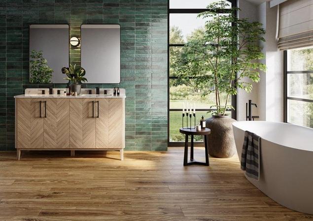 Bathroom with green accent wall tile and medium brown wood-look AquaGuard Performance flooring.