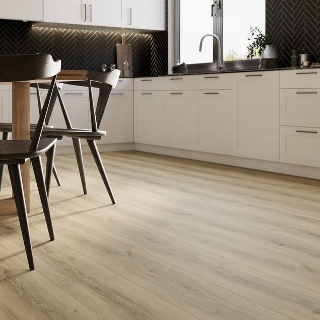 Kitchen with white cabinets and blonde NuCore flooring. 