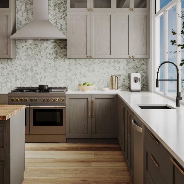 Kitchen with green marble herringbone backsplash.