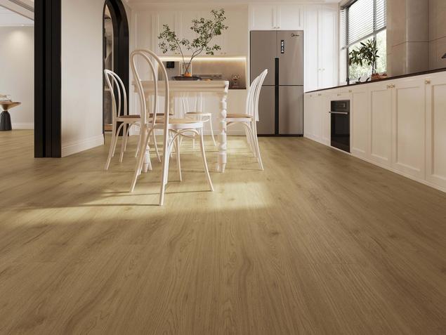 White kitchen with light-blonde wood-look NuCore flooring.