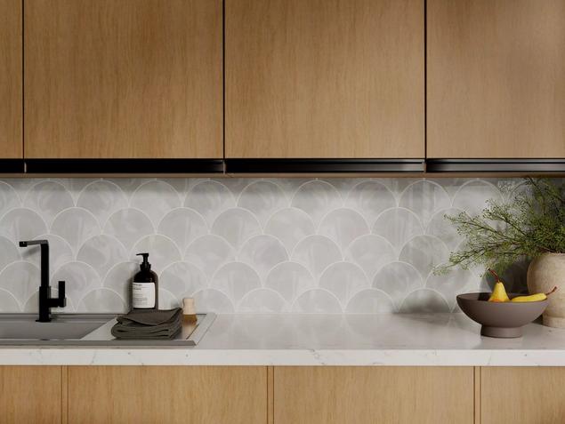 Kitchen with white marble fan mosaic backsplash. 