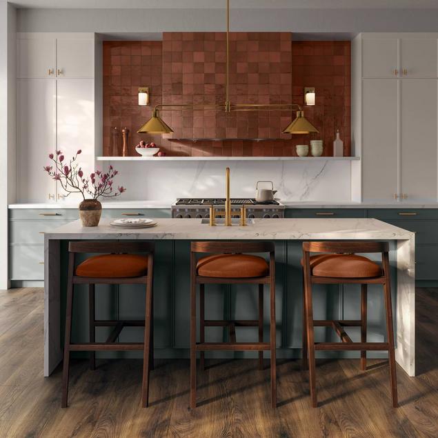 Kitchen with medium brown wood-look flooring and white marble-look tile backsplash. 