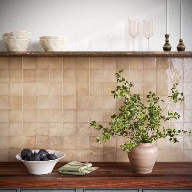 Kitchen with neutral beige square backsplash tile.