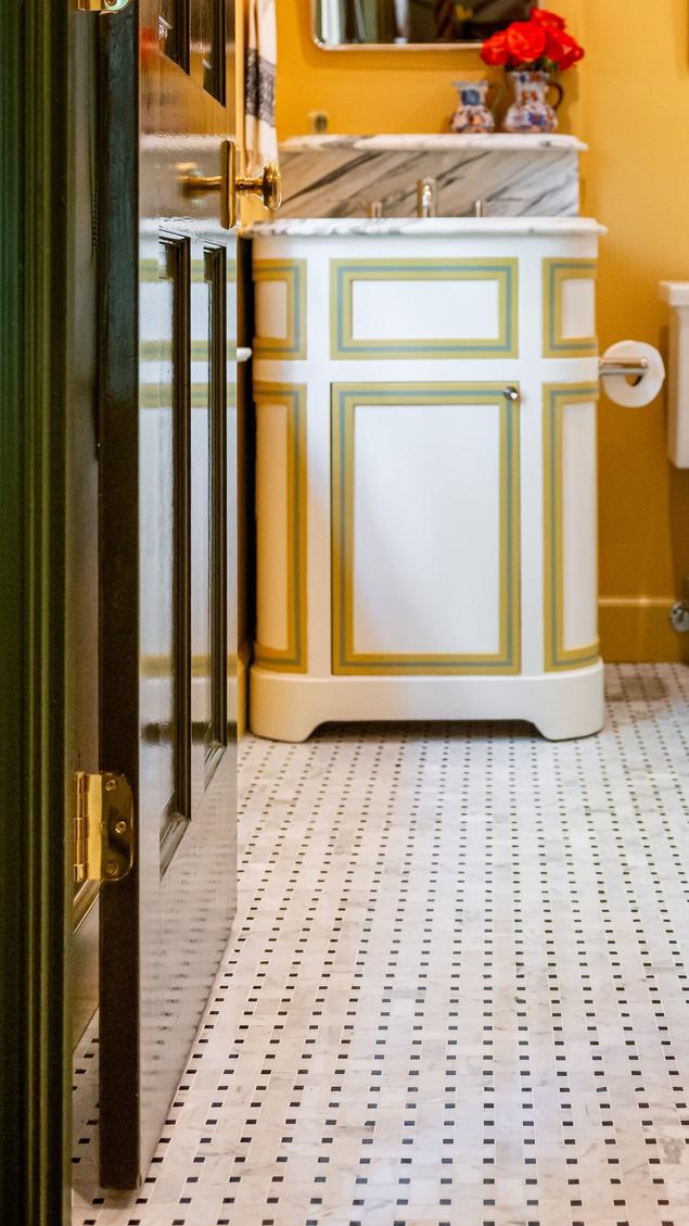 Close-up of the guest bathroom's basketweave pattern marble mosaic floors. 