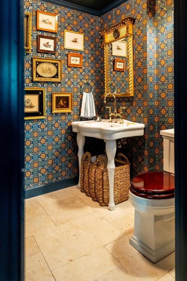 Powder bathroom with limestone flooring in a French lay pattern. 
