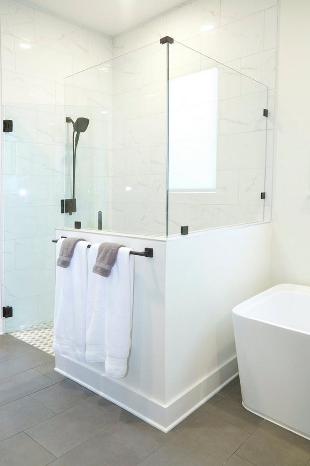 Shannon's bathroom with white stone-look shower wall tile and gray cement-look floor tile.