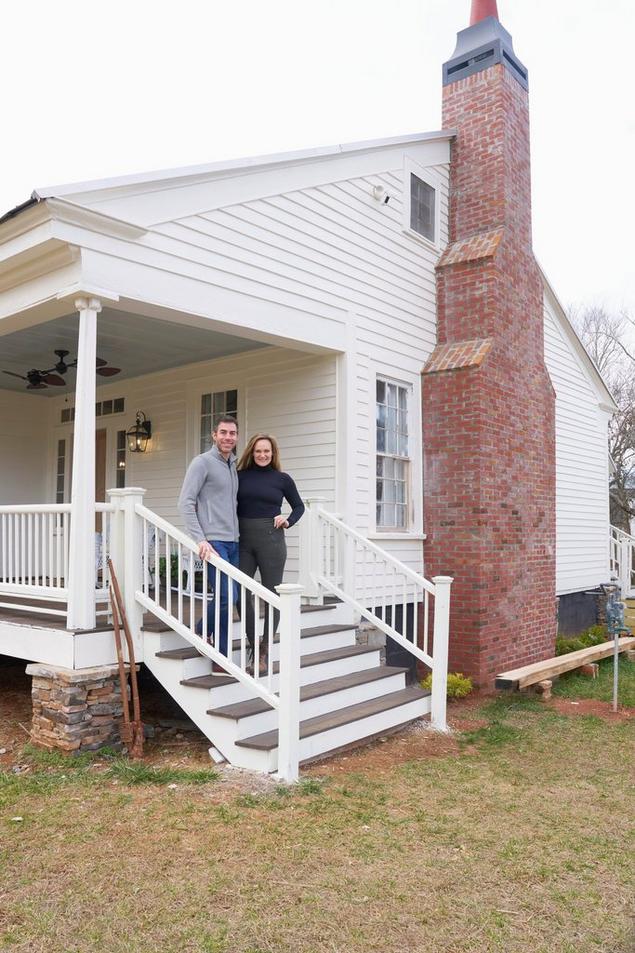 couple standing on steps of historic home