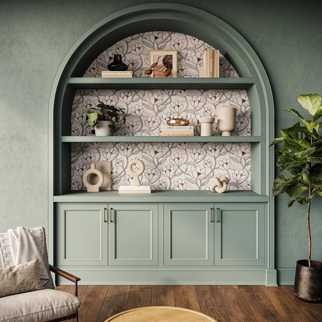 Living room with mint green walls, built-in bookshelf with floral mosaic backsplash and wood floors.