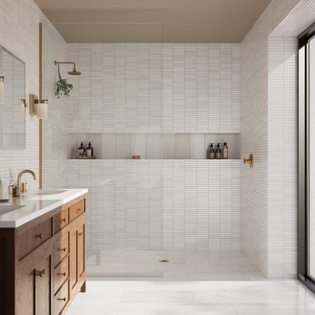 White marble bathroom with white marble shower walls, niche, and floors. 