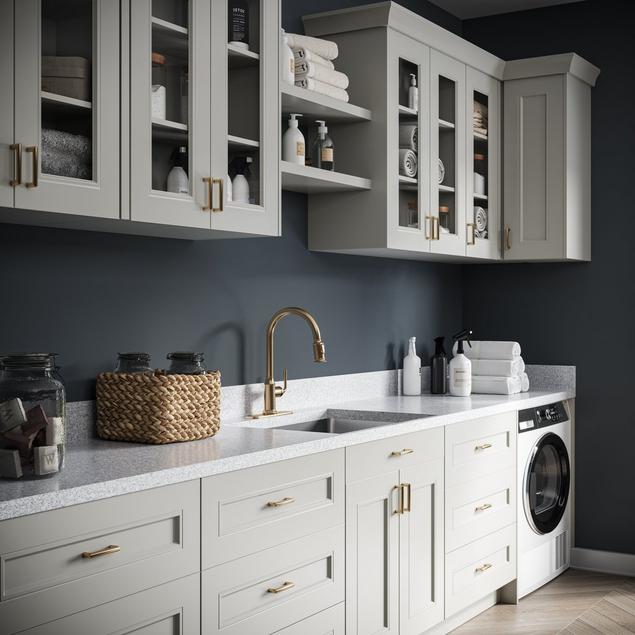 Blue laundry room with gray beaded shaker cabinets.