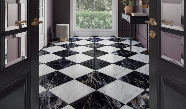 Close-up of a hallway's black and white marble flooring in a checkerboard pattern.