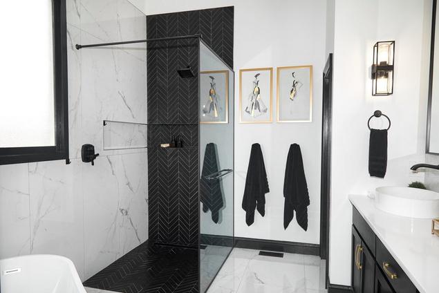 Black chevron mosaic and white stone look tile bathroom