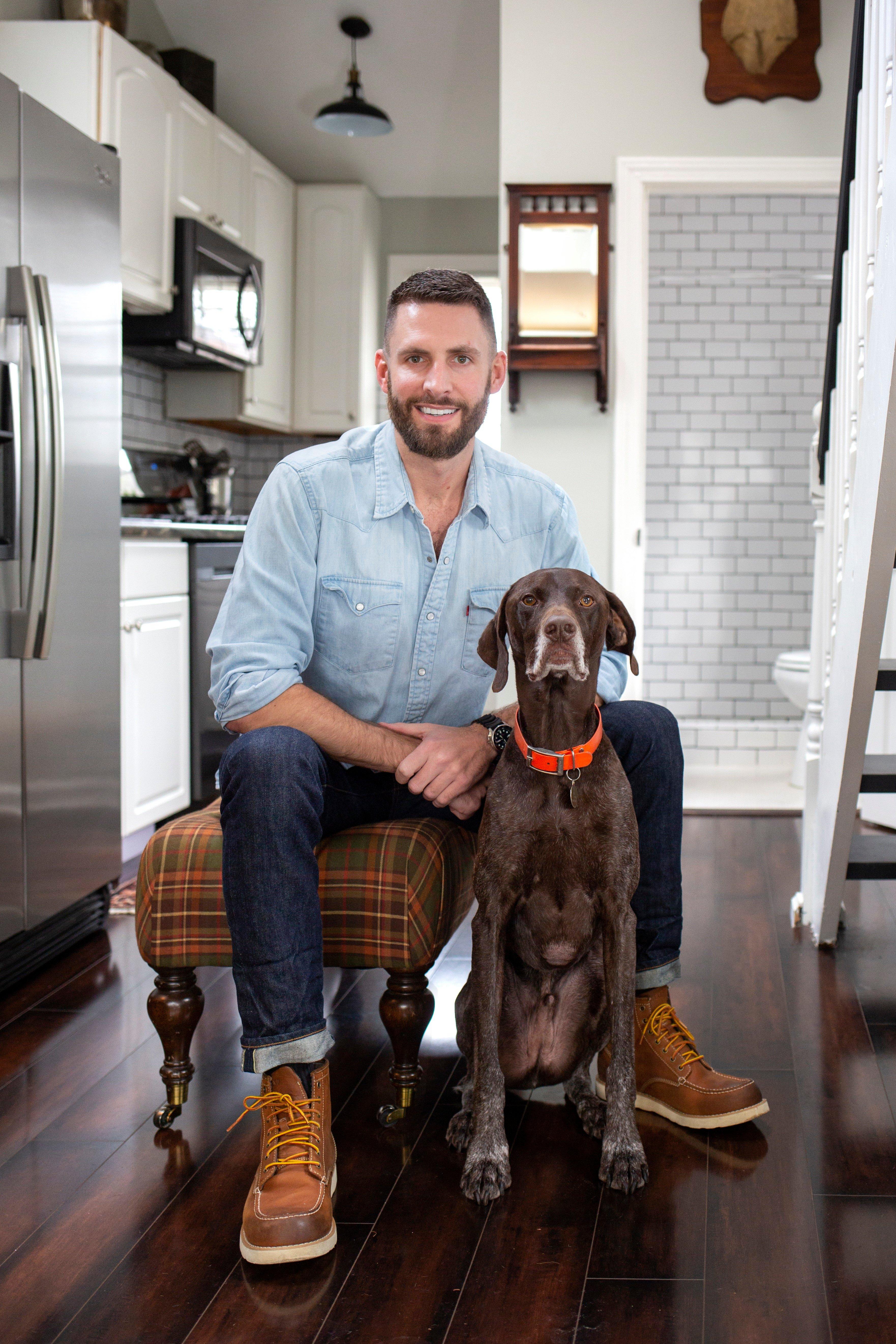 Man with dog in hardwood kitchen