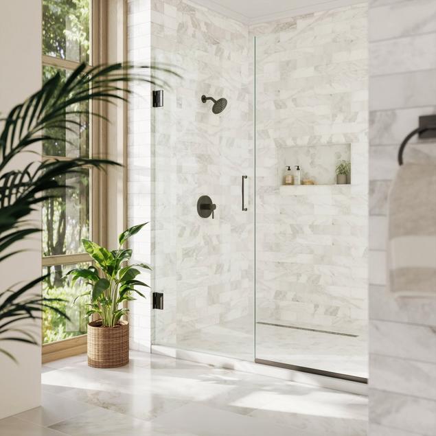 White marble shower with black fixtures and glass doors.