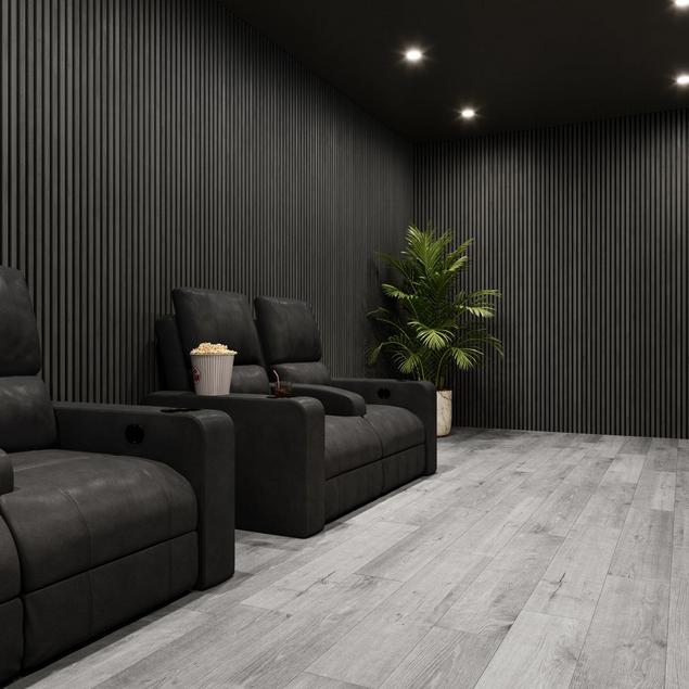 Home theater room with black acoustic wood panels and gray wood-look luxury vinyl plank flooring.
