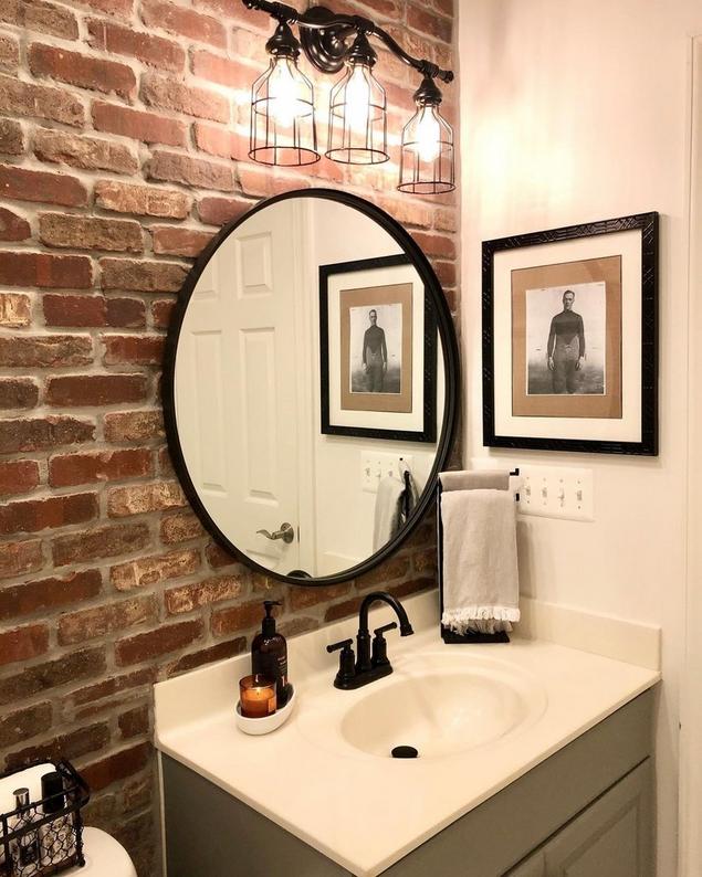 A brick wall in a bathroom.