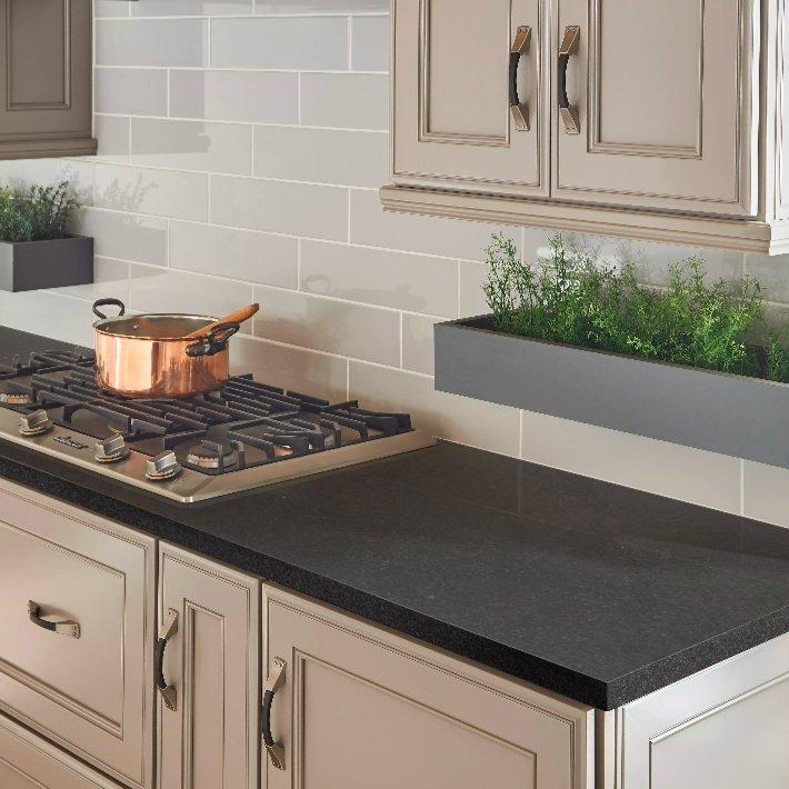 Black prefab countertops in kitchen with stove