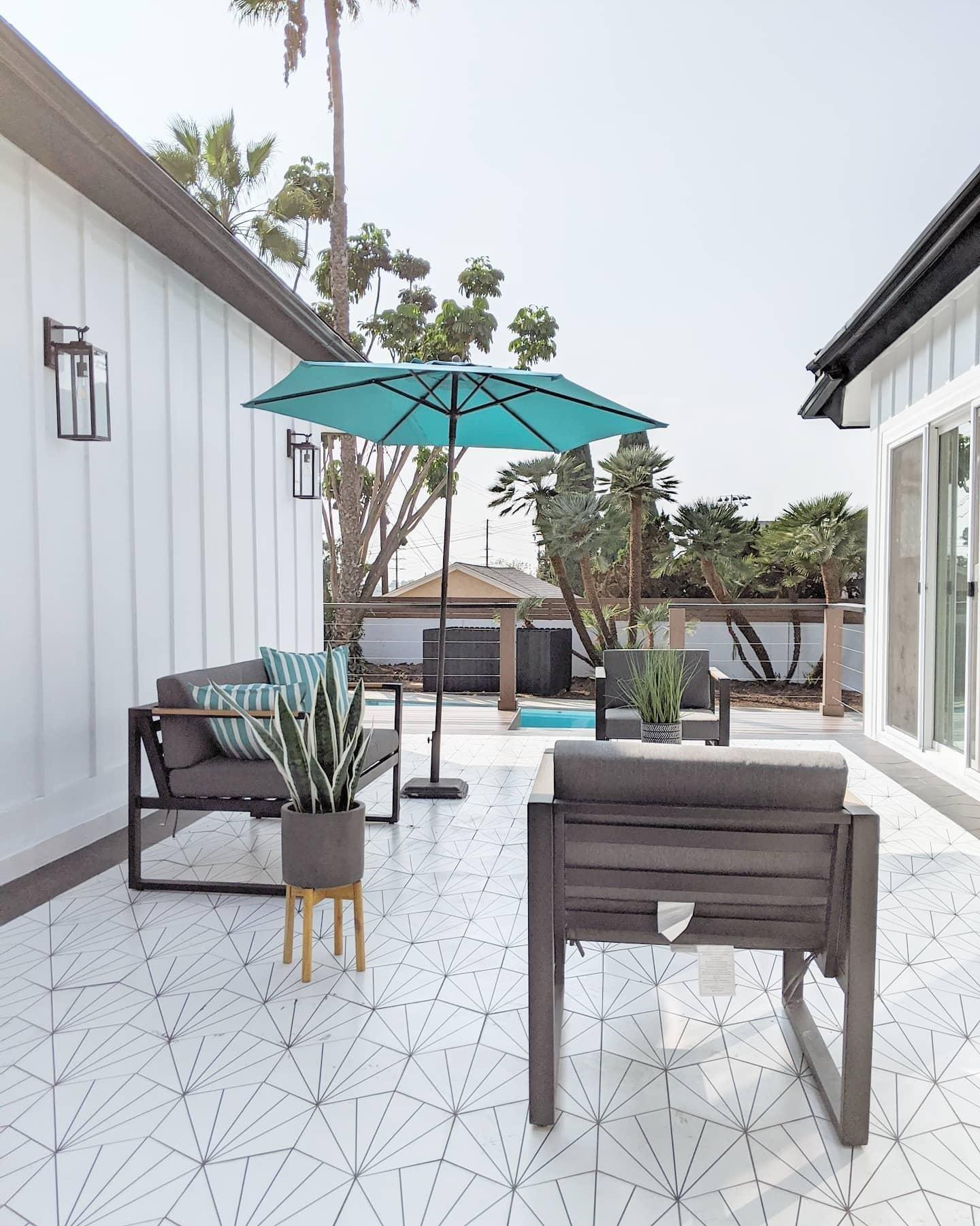 Kavala White Porcelain tile decorates the patio floor.