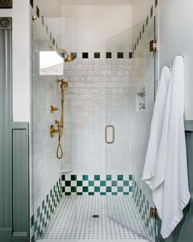 A shower featuring Zellige Perla polished ceramic tiles with a textured, handmade appearance.