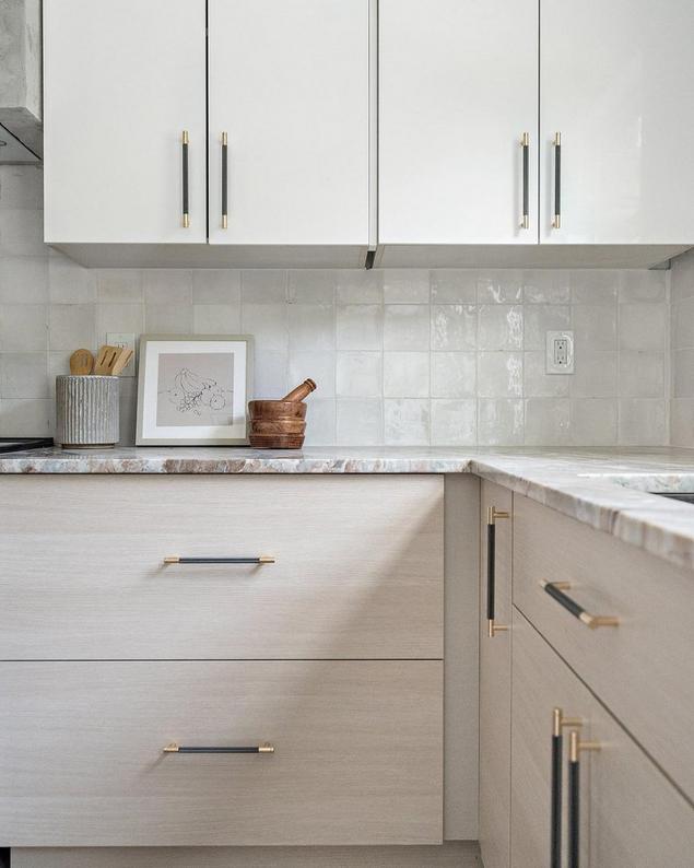 Organic modern kitchen with white zellige backsplash and light oak cabinets.