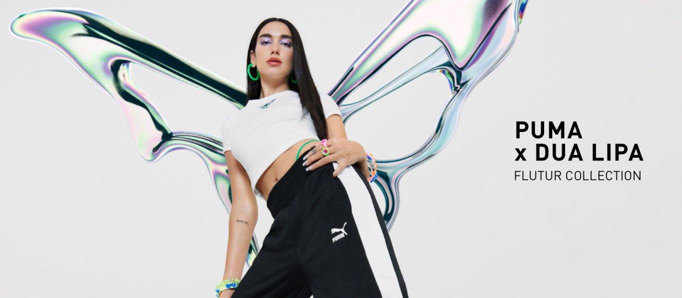 Dua Lipa i vit t-shirt och svarta byxor