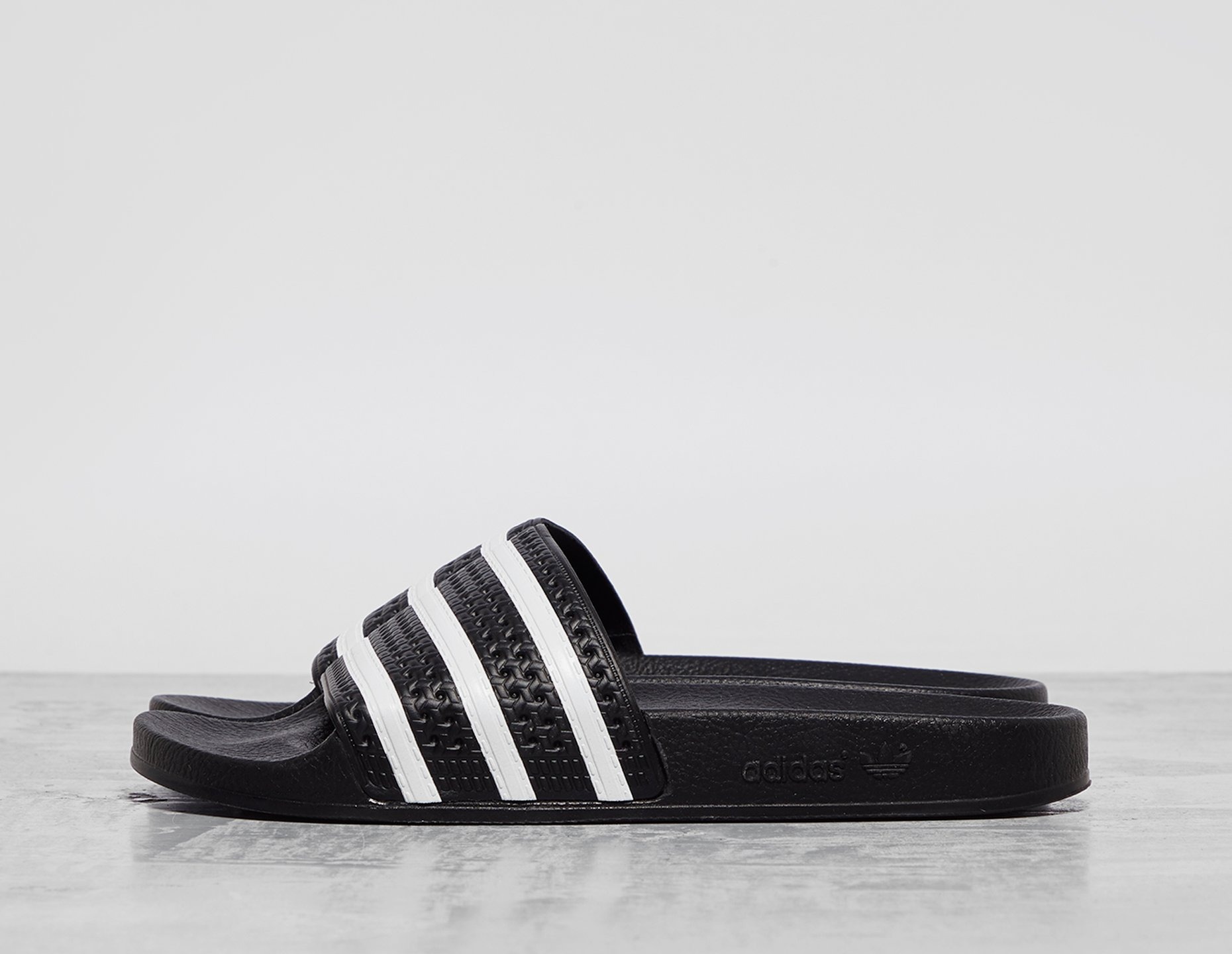 Black adidas Originals Adilette Slides | MissgolfShops | yeezy wave runner  laces black and grey shoes