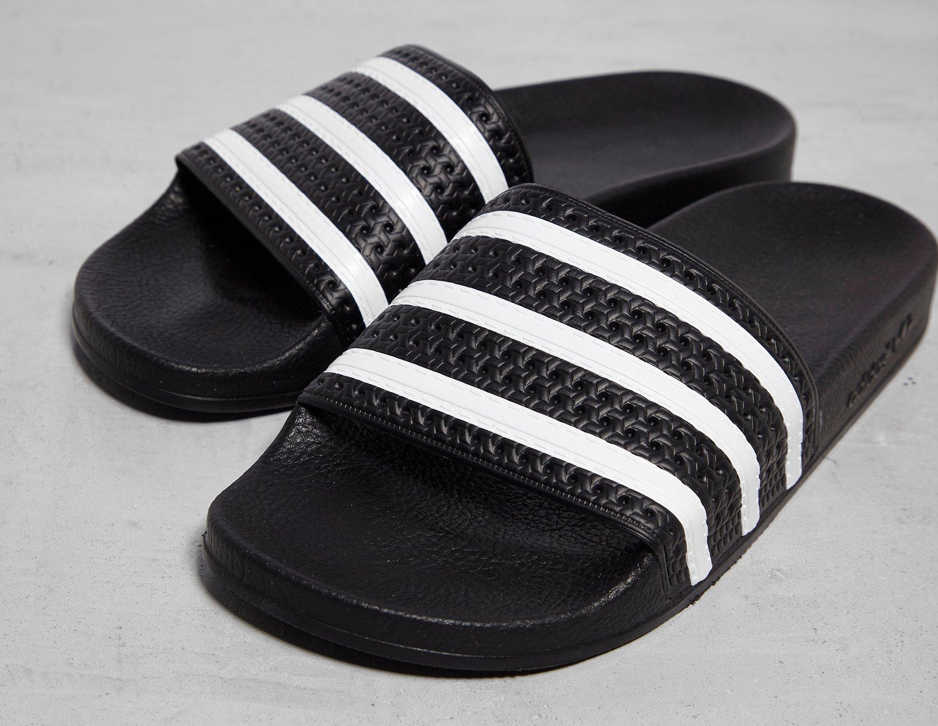 green and black adidas slides