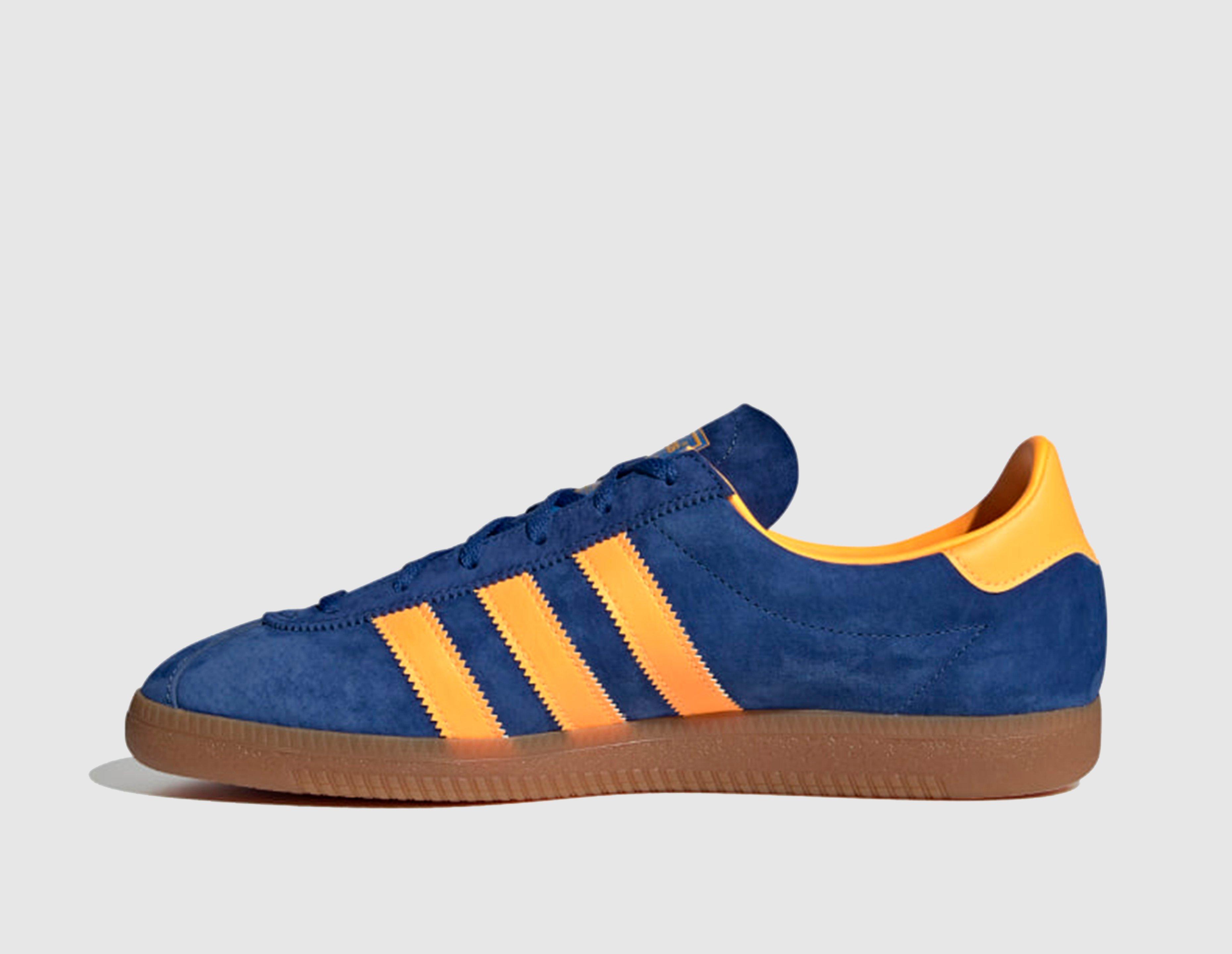 black adidas trainers with orange stripes